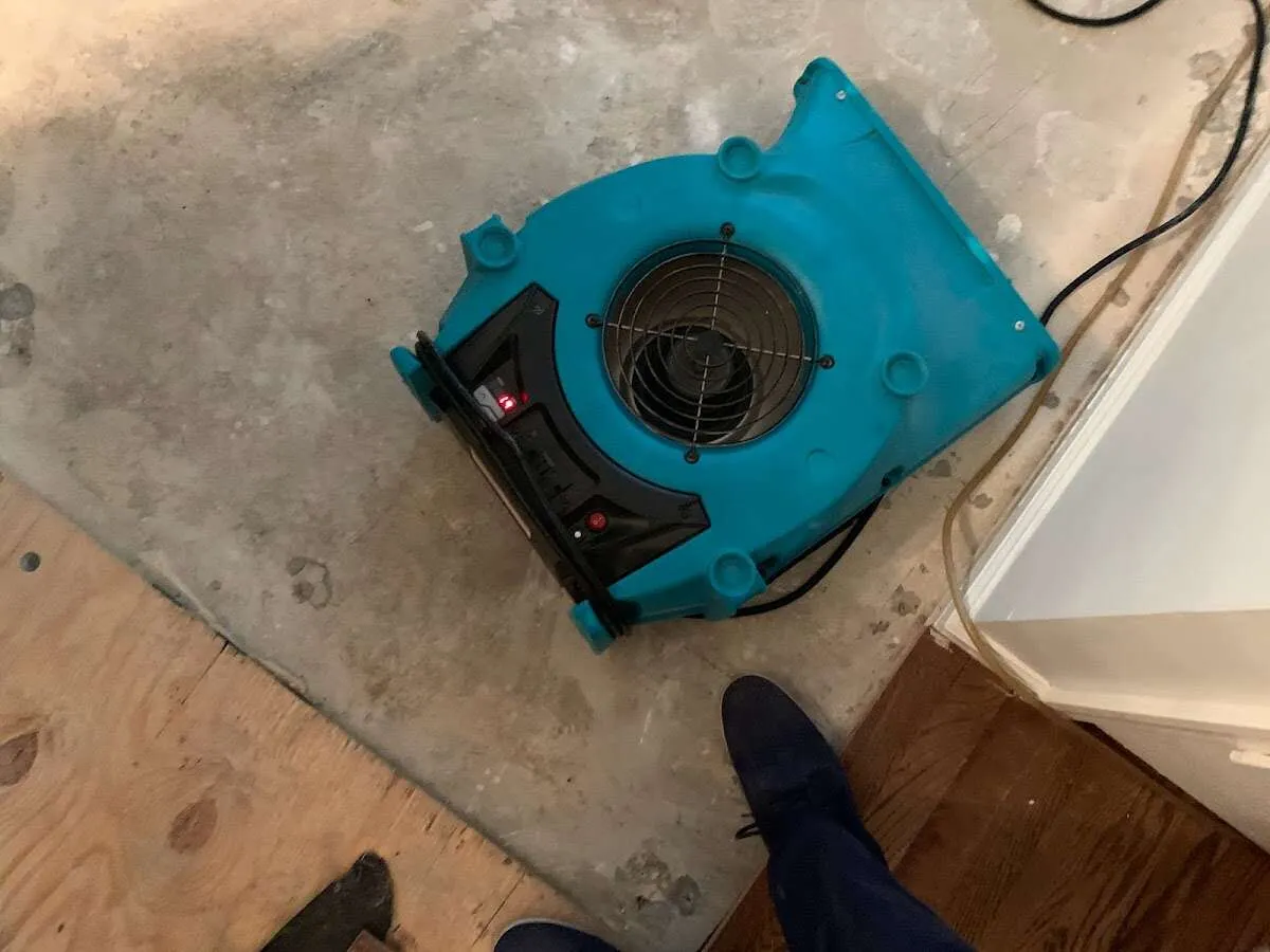 Air mover drying subfloor during Commercial Water Damage Restoration in Bossier City